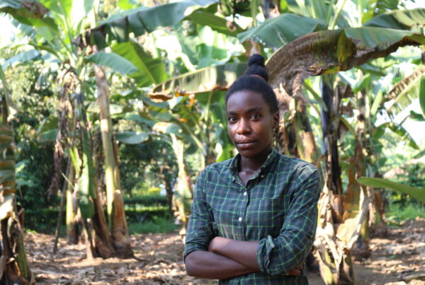 Woman standing in field of trees