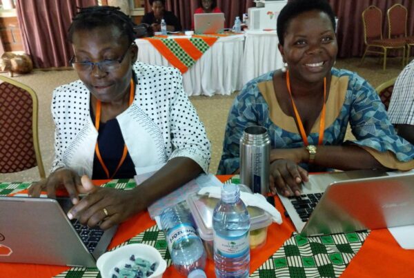 twp trainers sit at a table prepare at a training session