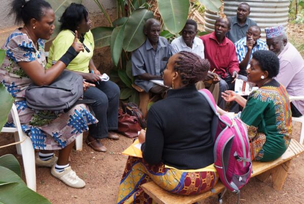 members of GREAT talk with farmers