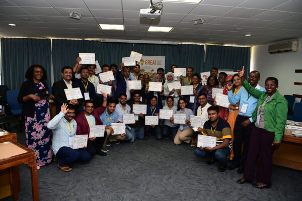 Participants hold their certificates