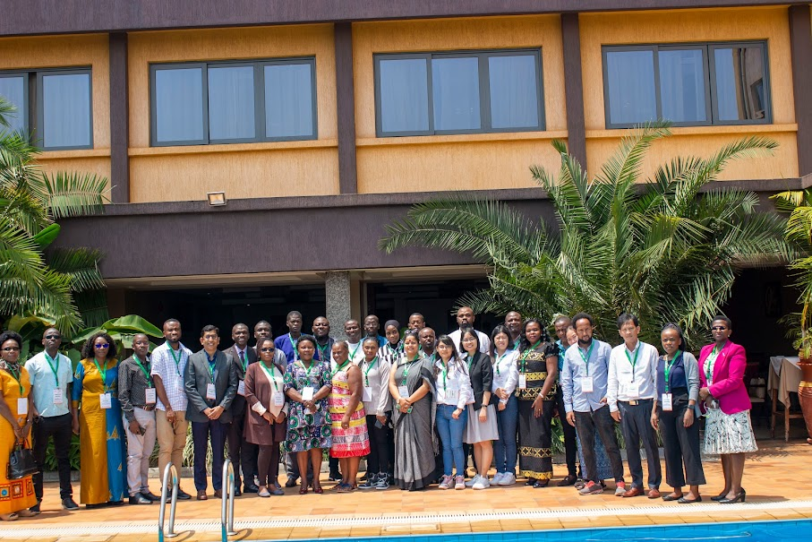 Participants pose for a group photo outside of hotel conference room